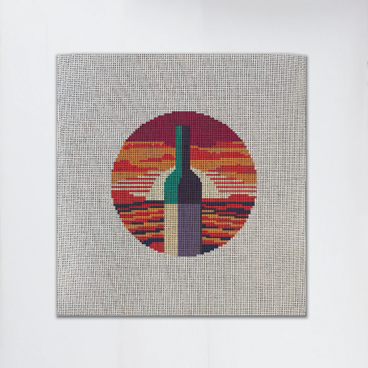 Needlepoint canvas with a wine and sunset design on it