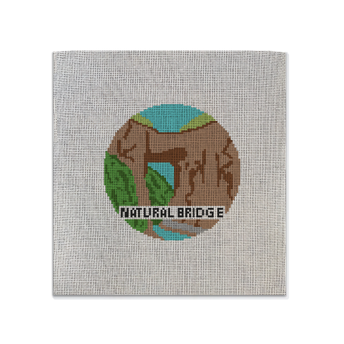 Painted needlepoint canvas featuring a natural bridge design on it